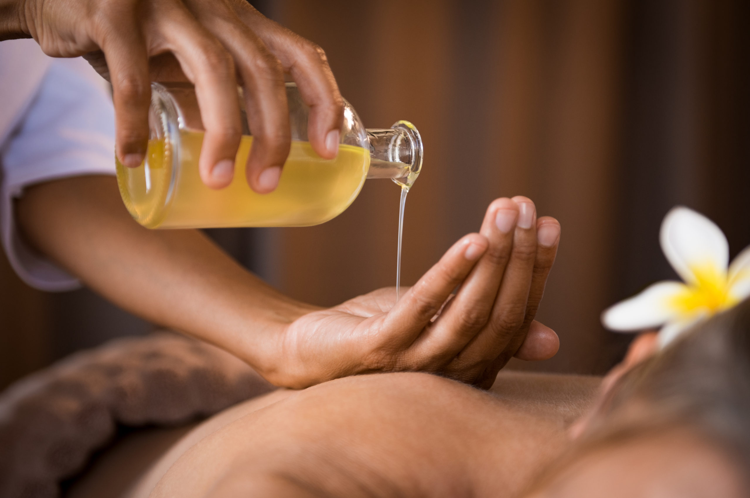 A person receiving a soothing back massage with oil, promoting relaxation and tension relief