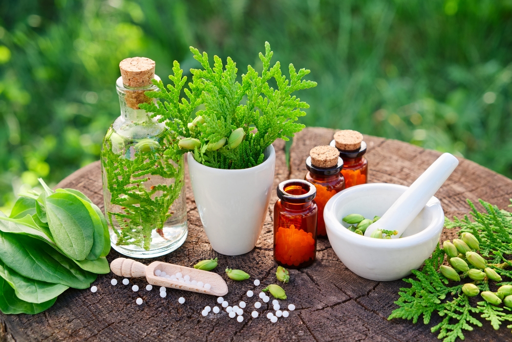 Various herbal and natural medicines neatly arranged on a table, showcasing alternative health remedies